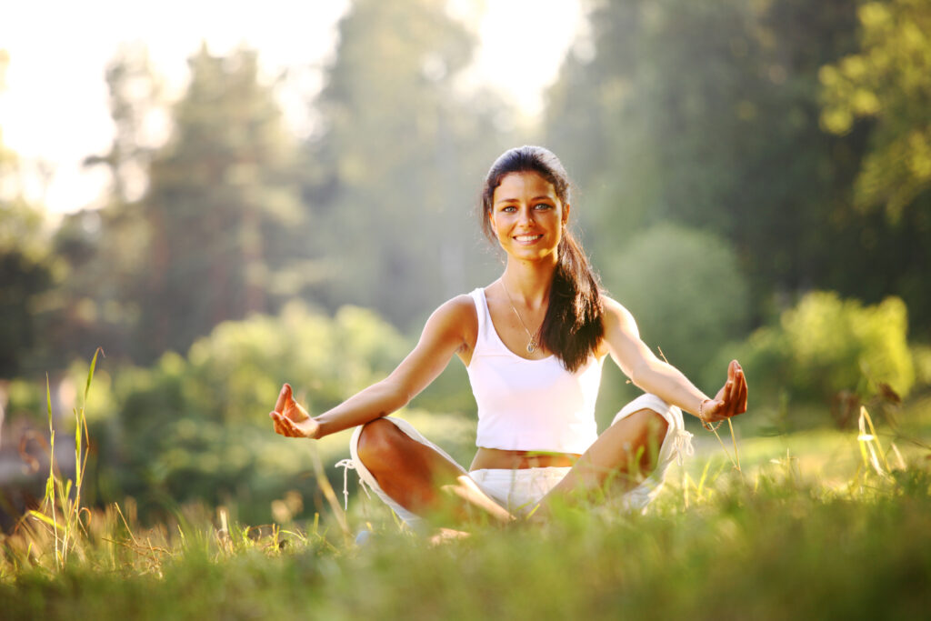 Young girl doing yoga in the park